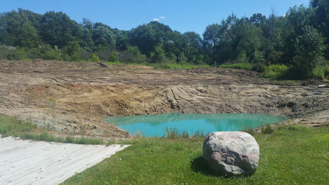 Holly, Michigan Placing rocks around pond (14)