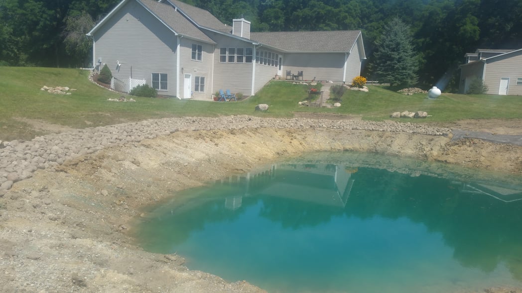 Holly, Michigan Placing rocks around pond (23)