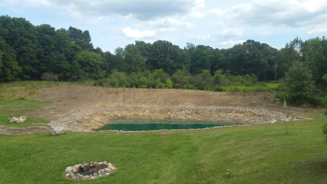 Holly, Michigan Placing rocks around pond (25)