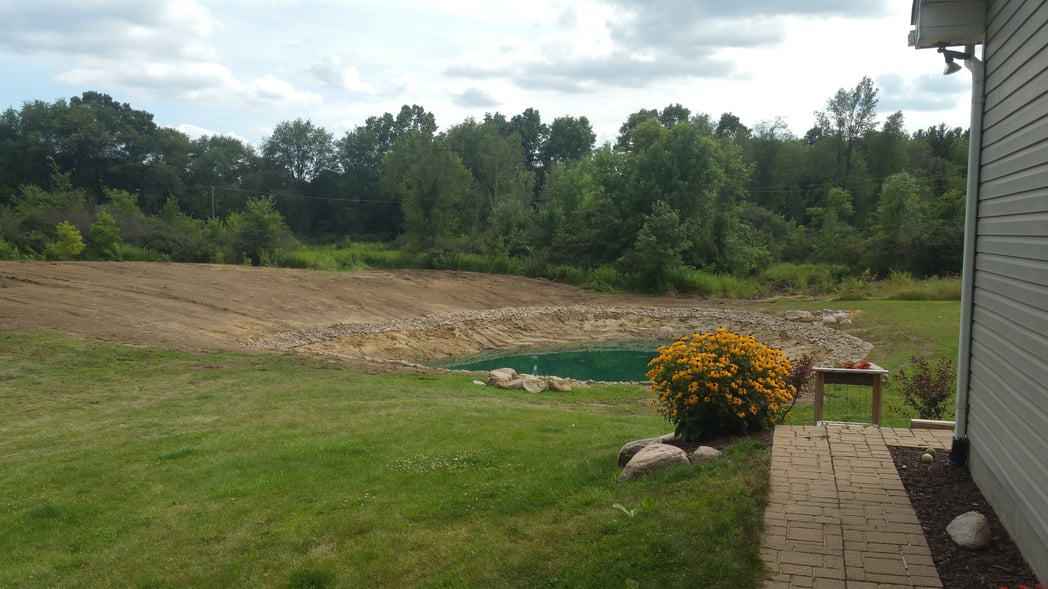 Holly, Michigan Placing rocks around pond (29)